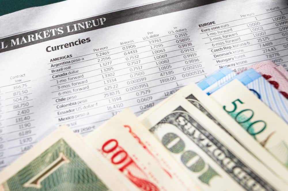 A currency exchange chart with currency from several countries on top of the chart.